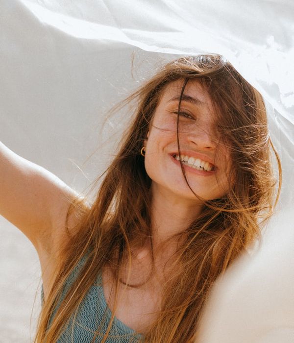 Woman feeling energetic and fresh in a bright room.